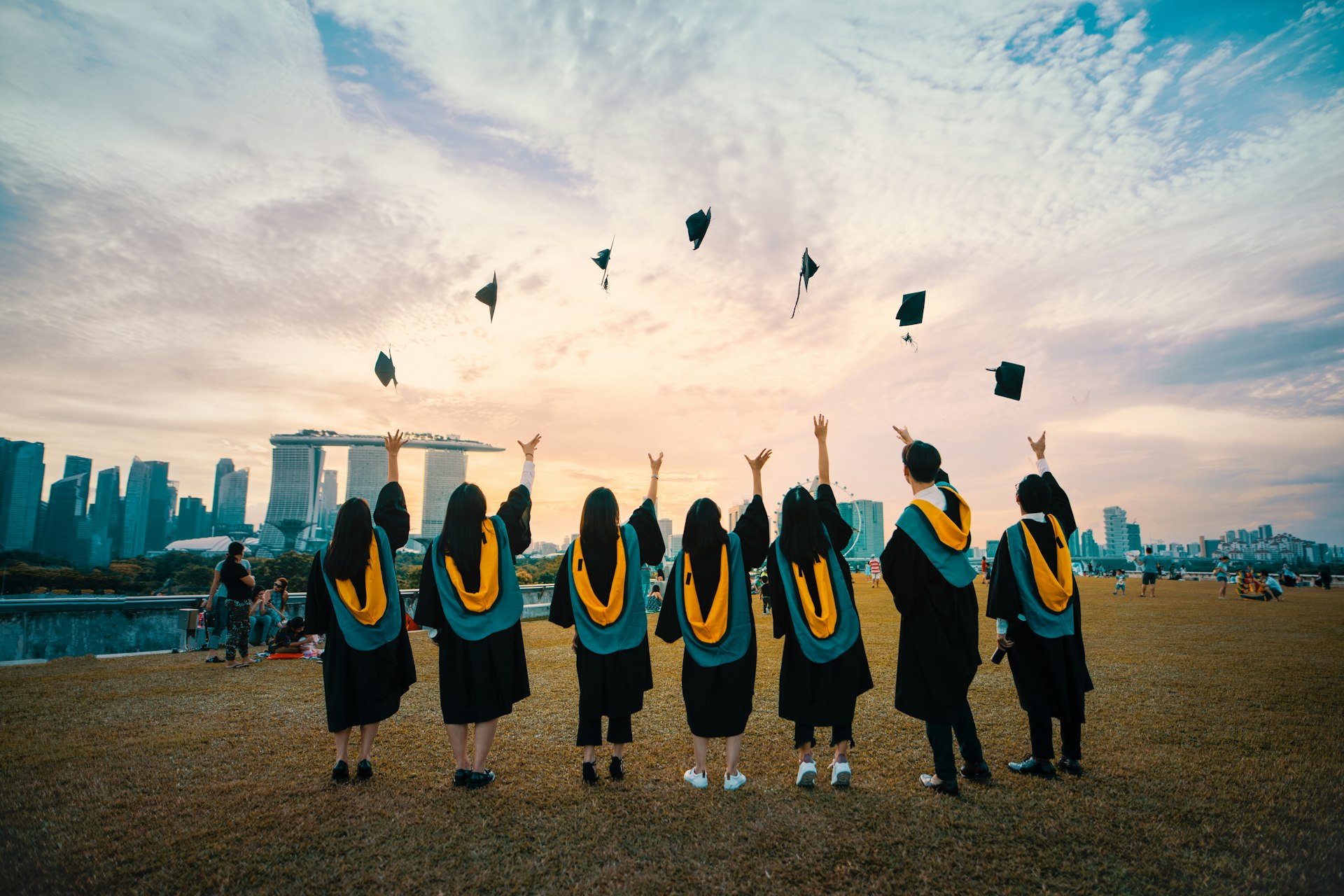 Graduates celebrating at sunset after receiving their grants